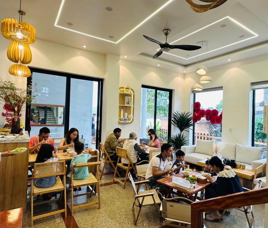 a group of people sitting at tables in a restaurant at Sunsea House-Đá Đĩa Phú Yên in Tuy An