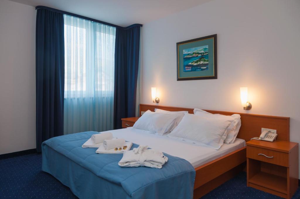 Postel nebo postele na pokoji v ubytování Hotel Rotondo