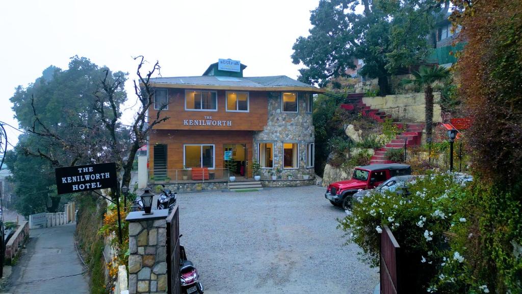 a house with a truck parked in front of it at The Kenilworth Mussoorie by Stotrak On Mall Road with On-site Parking in Mussoorie