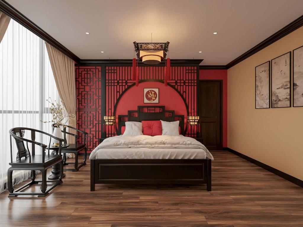 a bedroom with a large bed and a chair at Dal Vostro Vinhomes Ocean Park 2 in Ðình Loan