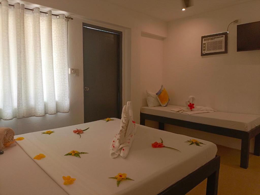 Postel nebo postele na pokoji v ubytování Palmera El Nido Inn