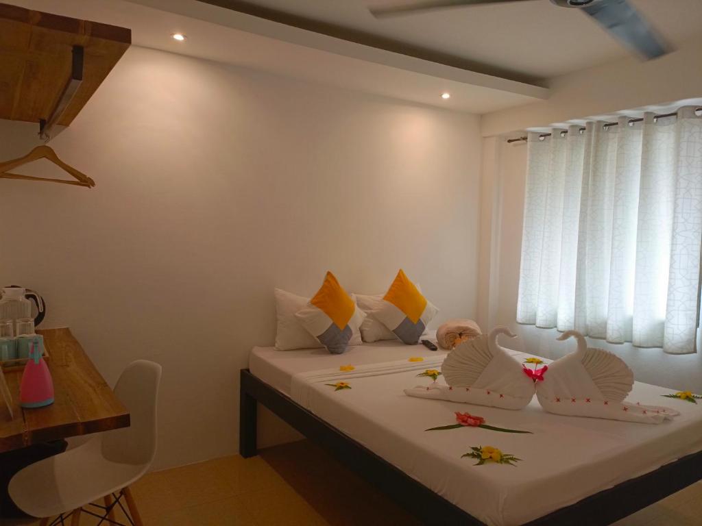 Postel nebo postele na pokoji v ubytování Palmera El Nido Inn