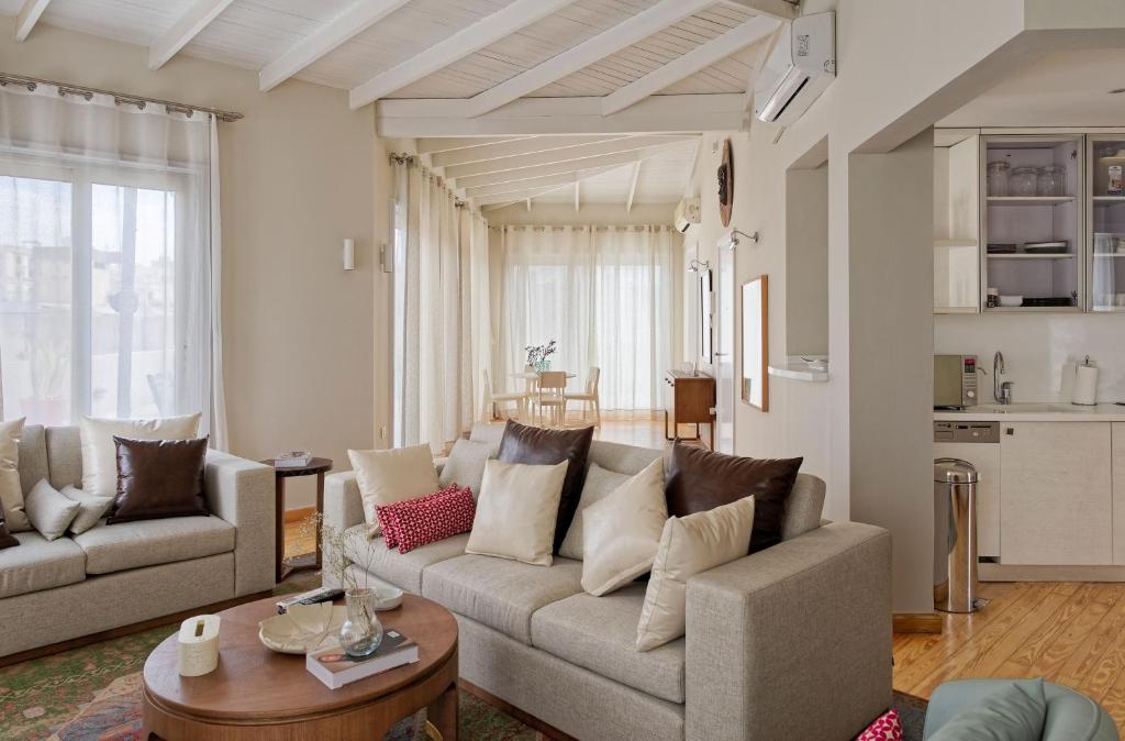 a living room with two couches and a table at VESTA - Heliopolis Residence in Cairo