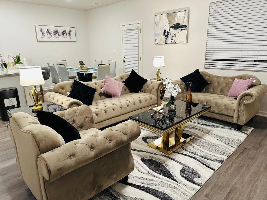 a living room with two couches and a table at Modern comfort house in Madison