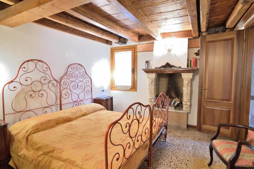 a bedroom with a large bed and a fireplace at Papa Paolo II in Venice