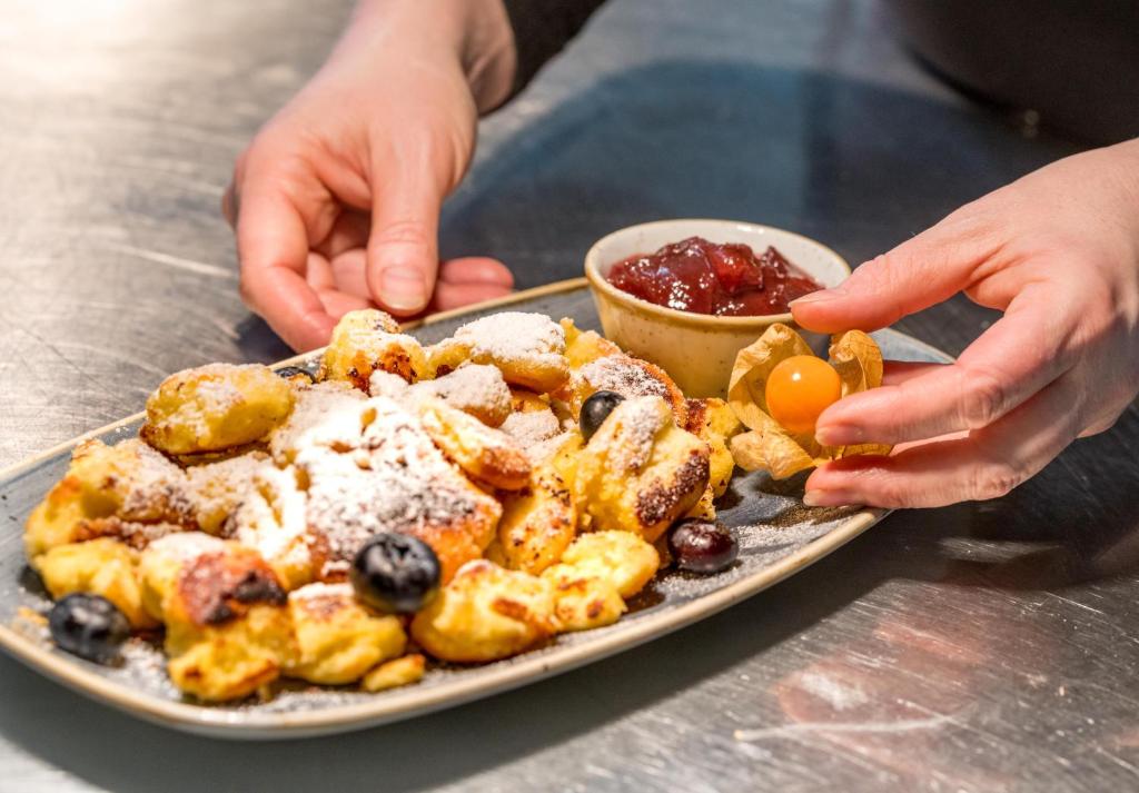 a plate of food with a plate of biscuits and an egg at Gasthof - Auszeit im Bad Diezlings - Adults only in Hörbranz