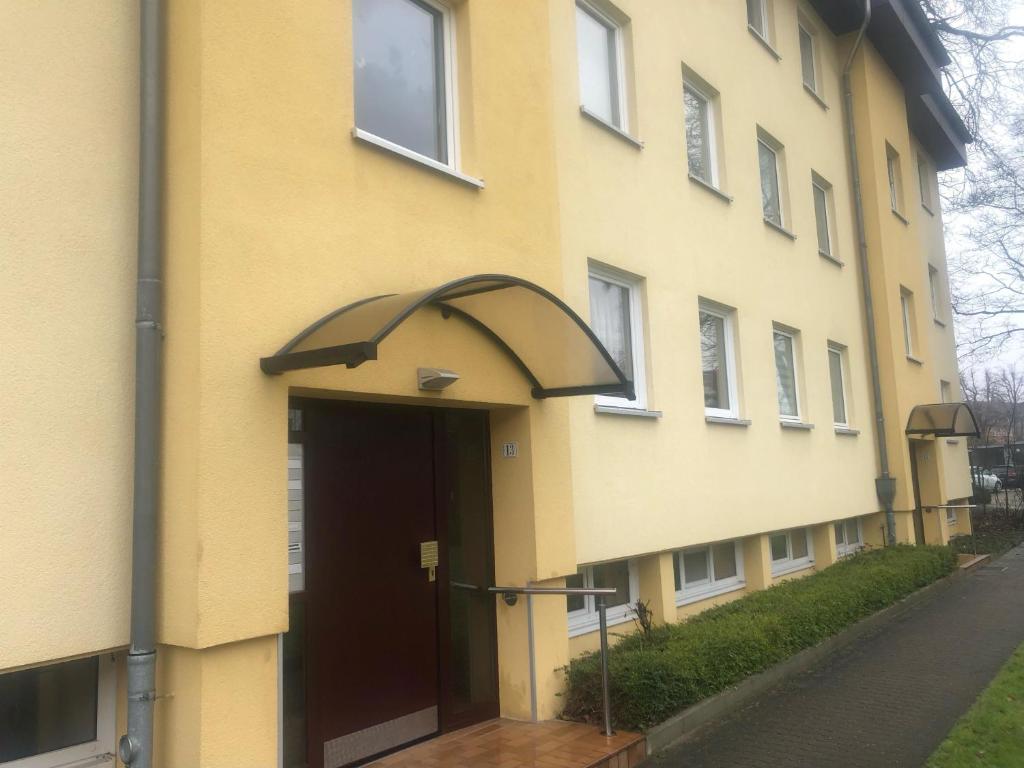 a yellow building with an umbrella over the door at Ferienwohnung Folke-Bernadotte in Lübeck