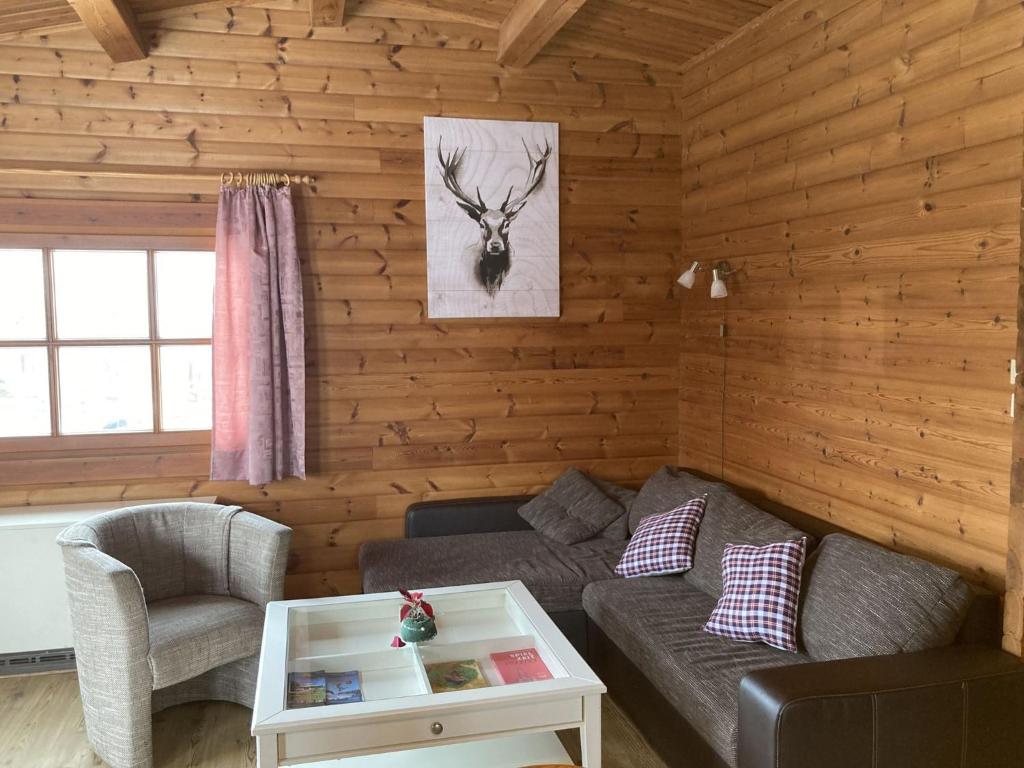 a living room with a couch and a table at Hasselhäuser Hasselhaus 4 in Hasselfelde