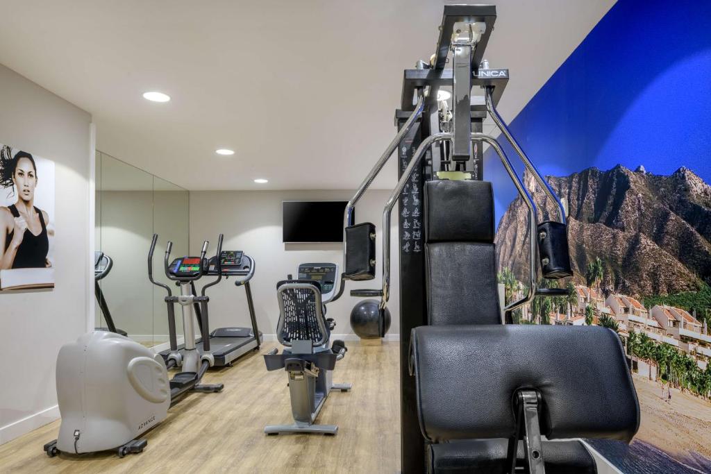 a gym with exercise equipment in a room at NH Collection Marbella in Marbella
