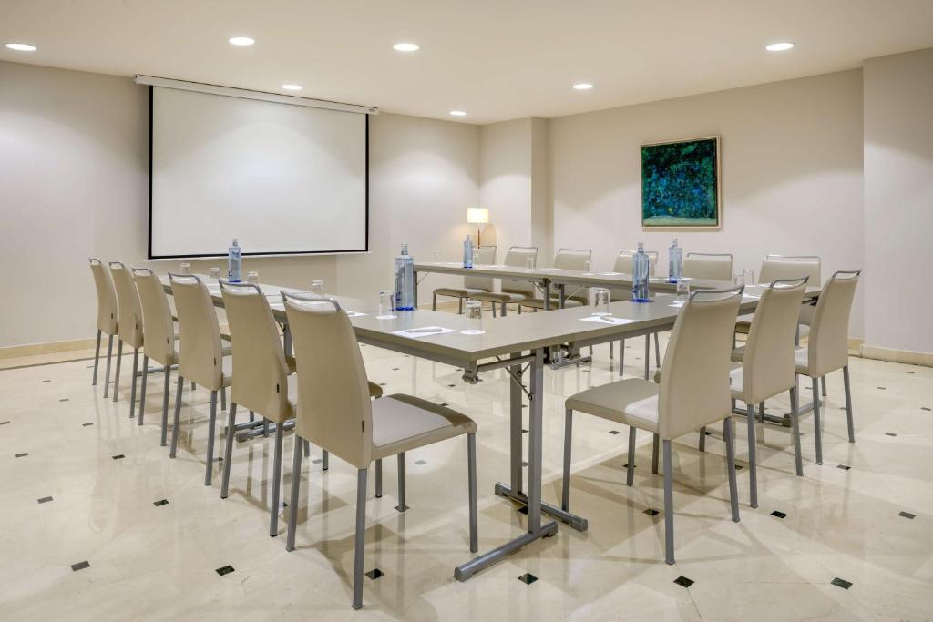 a conference room with a long table and chairs at NH Collection Marbella in Marbella