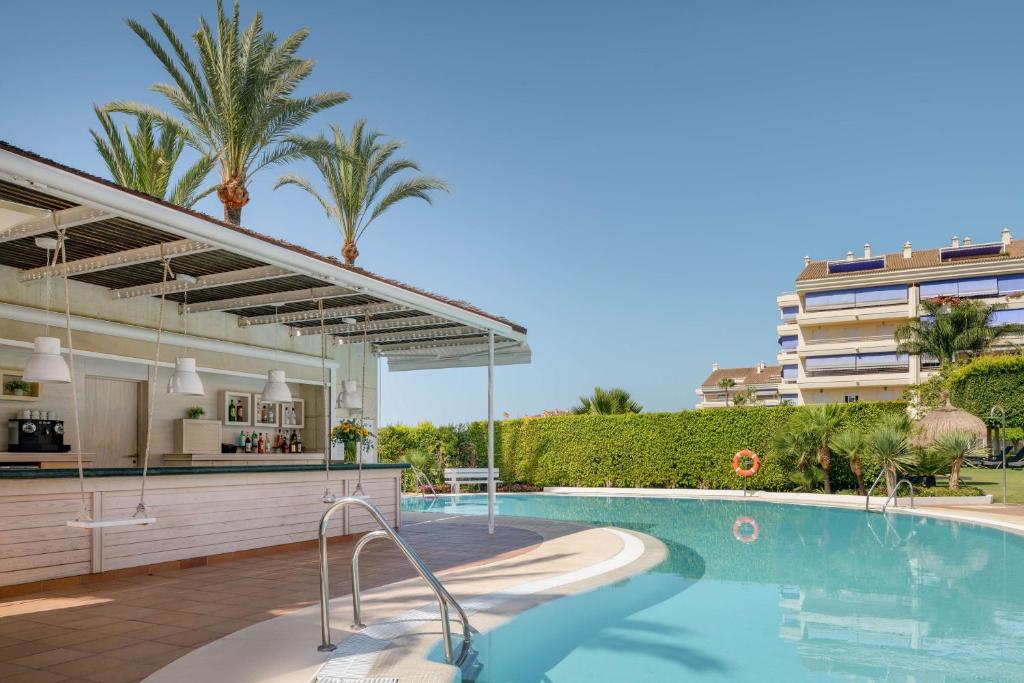 a swimming pool in a building with a resort at NH Collection Marbella in Marbella