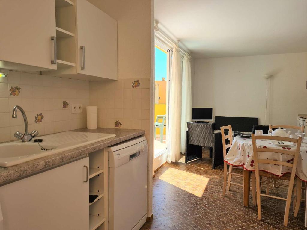 Il dispose d'une cuisine avec un évier et d'une salle à manger avec une table. dans l'établissement 3 pièces mezzanine CAP D 'AGDE CT200-724, au Cap d'Agde