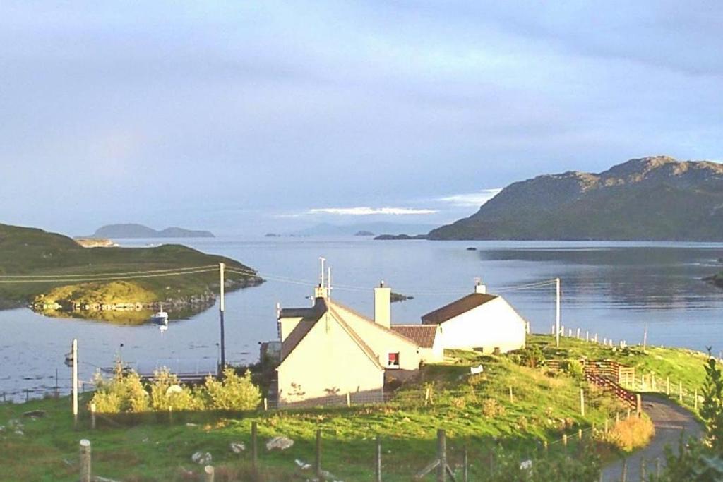 a house on an island in a body of water at Shiant View in Lochs