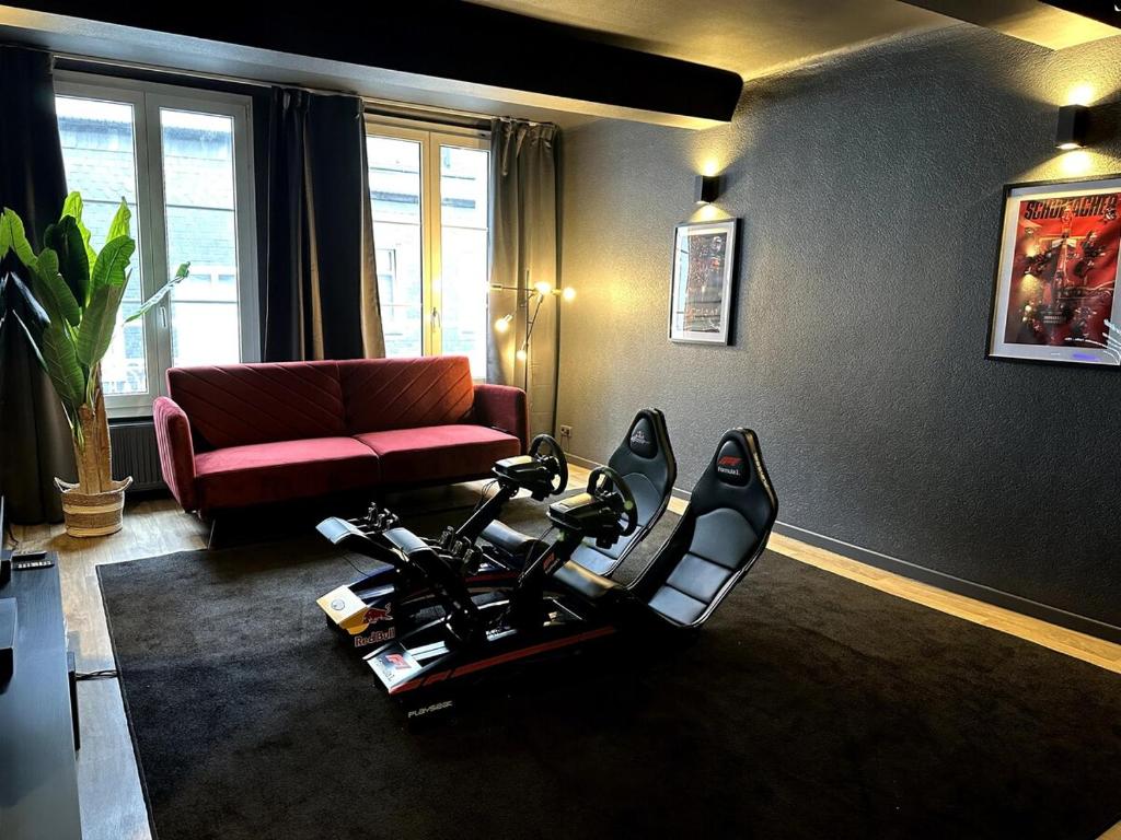 a living room with a bike in the middle of a room at F1 Experience Lodge Spa-Francorchamps in Malmedy