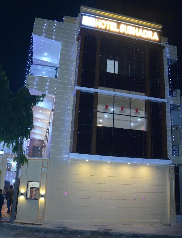 a hotel building with a sign on it at night at Hotel Subhadra in Kannauj