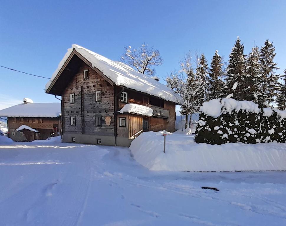 a wooden barn with snow on the ground at Almliesl STVE-733 in Sankt Veit im Pongau