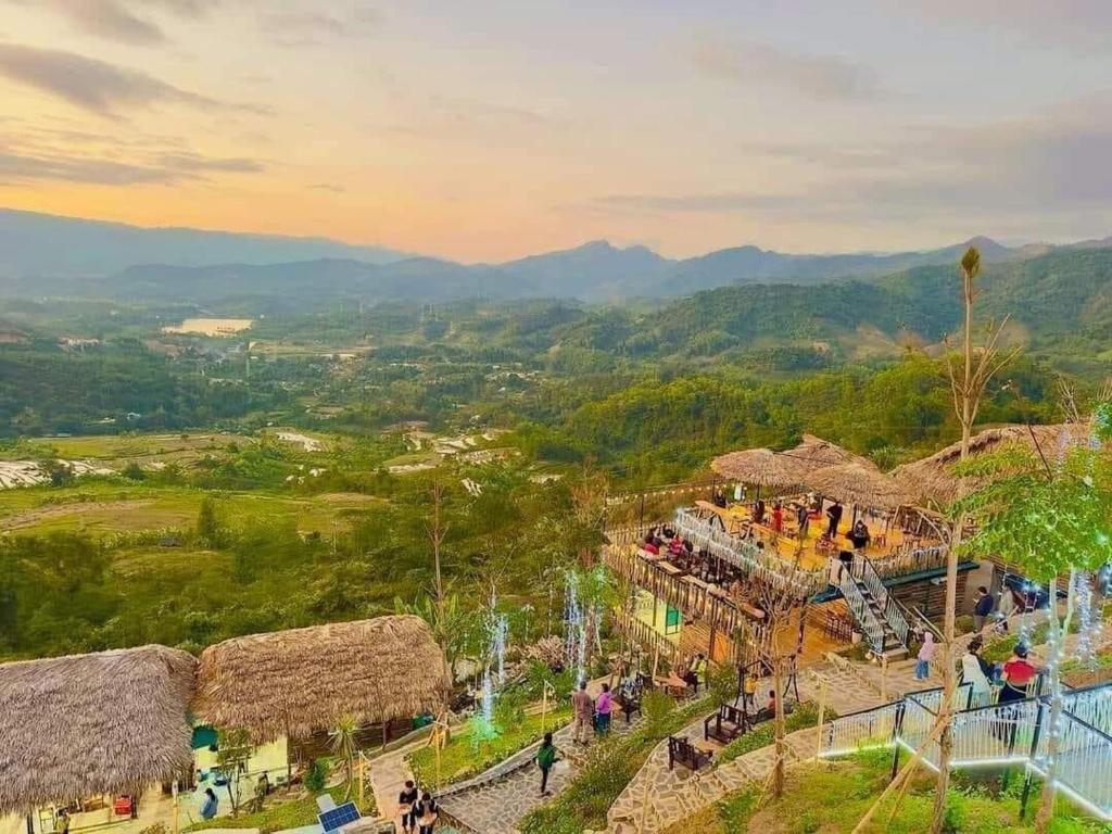 a group of people walking around a amusement park at Khu sinh thái Ecolodge Kê Nênh Điện Biên in Ban Hin Lom