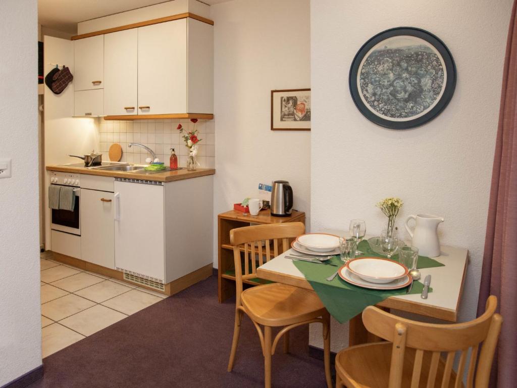 a kitchen and dining room with a table and chairs at Apartment Chalet Abendrot apARTments-3 by Interhome in Grindelwald