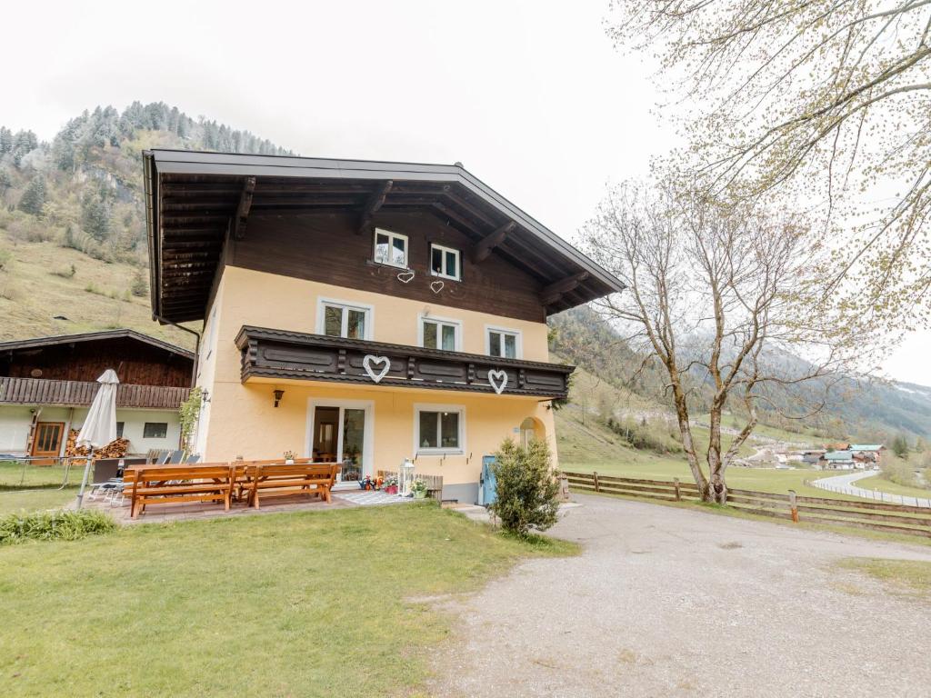 a house with a picnic table in front of it at Holiday Home Bergfried by Interhome in Fusch an der Glocknerstraße