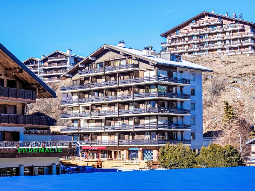a large apartment building on the side of a mountain at Apartment Beau-Séjour 24 by Interhome in Nendaz