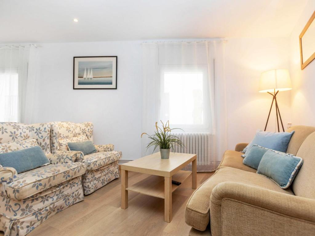 a living room with two couches and a table at Apartment Gregal by Interhome in Tossa de Mar