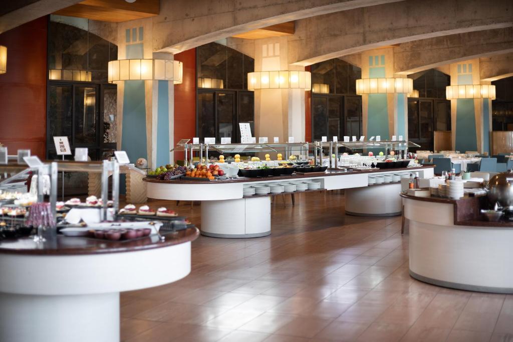 a restaurant with a buffet line of food at MUR Faro Jandia Fuerteventura & Spa in Morro del Jable
