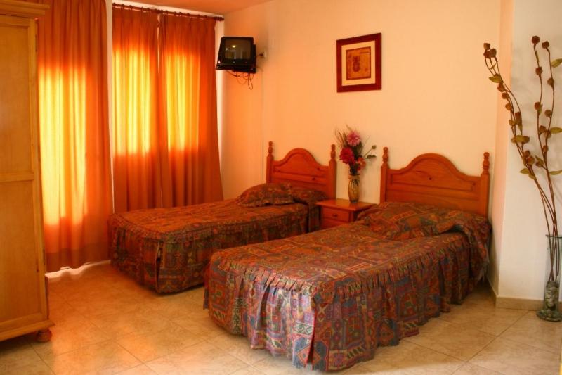 Postel nebo postele na pokoji v ubytování Hotel Limas
