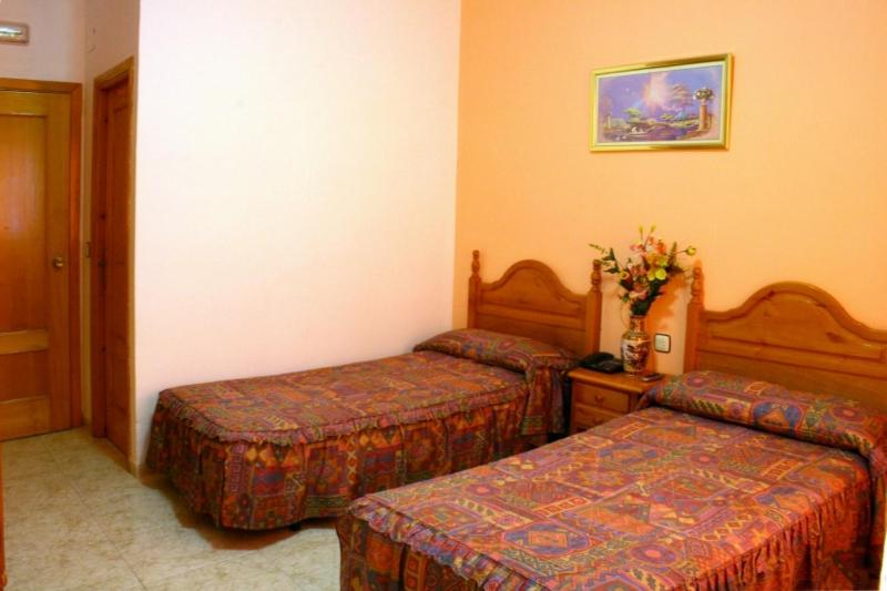 Postel nebo postele na pokoji v ubytování Hotel Limas