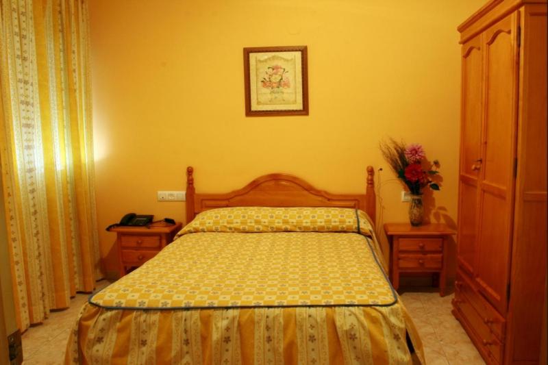 Postel nebo postele na pokoji v ubytování Hotel Limas
