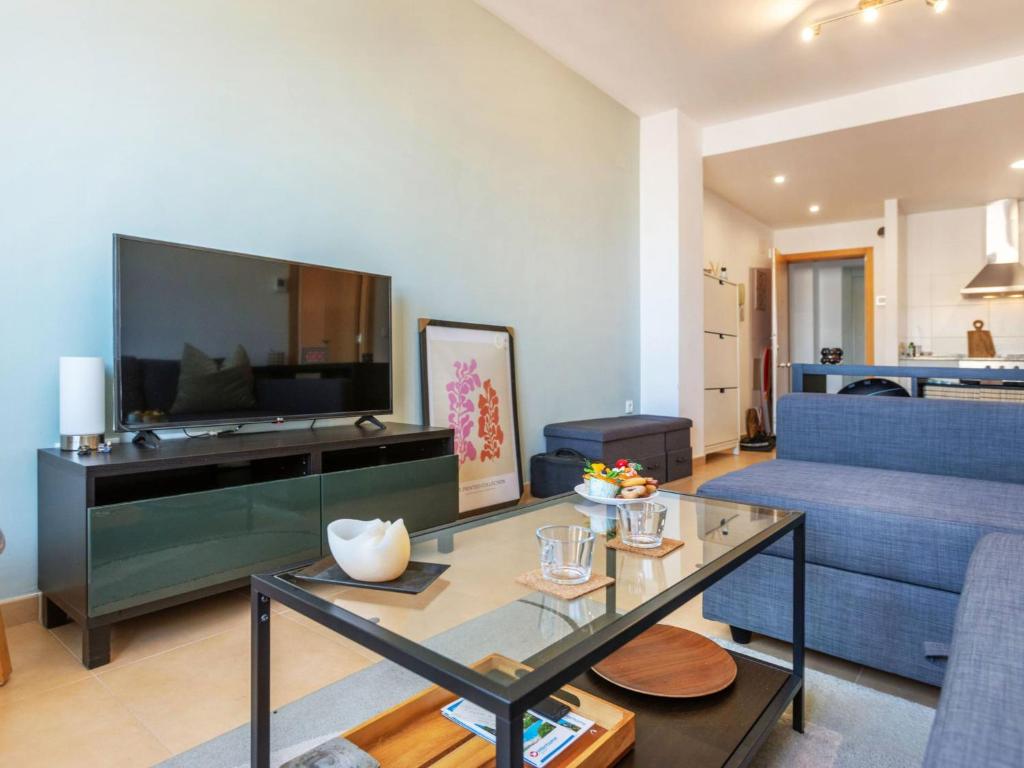 a living room with a blue couch and a table at Apartment Maxxie by Interhome in Benicarló