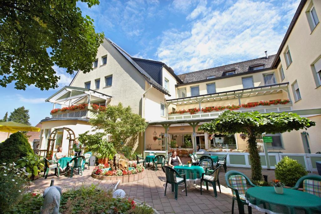 a patio of a hotel with tables and chairs at Hotel Lindenhof in Warstein