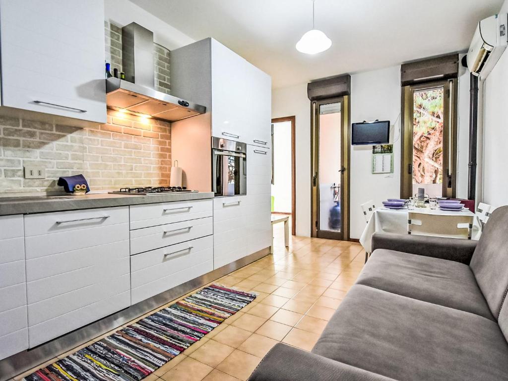 a living room with a couch and a kitchen at Apartment Antony by Interhome in Rosapineta