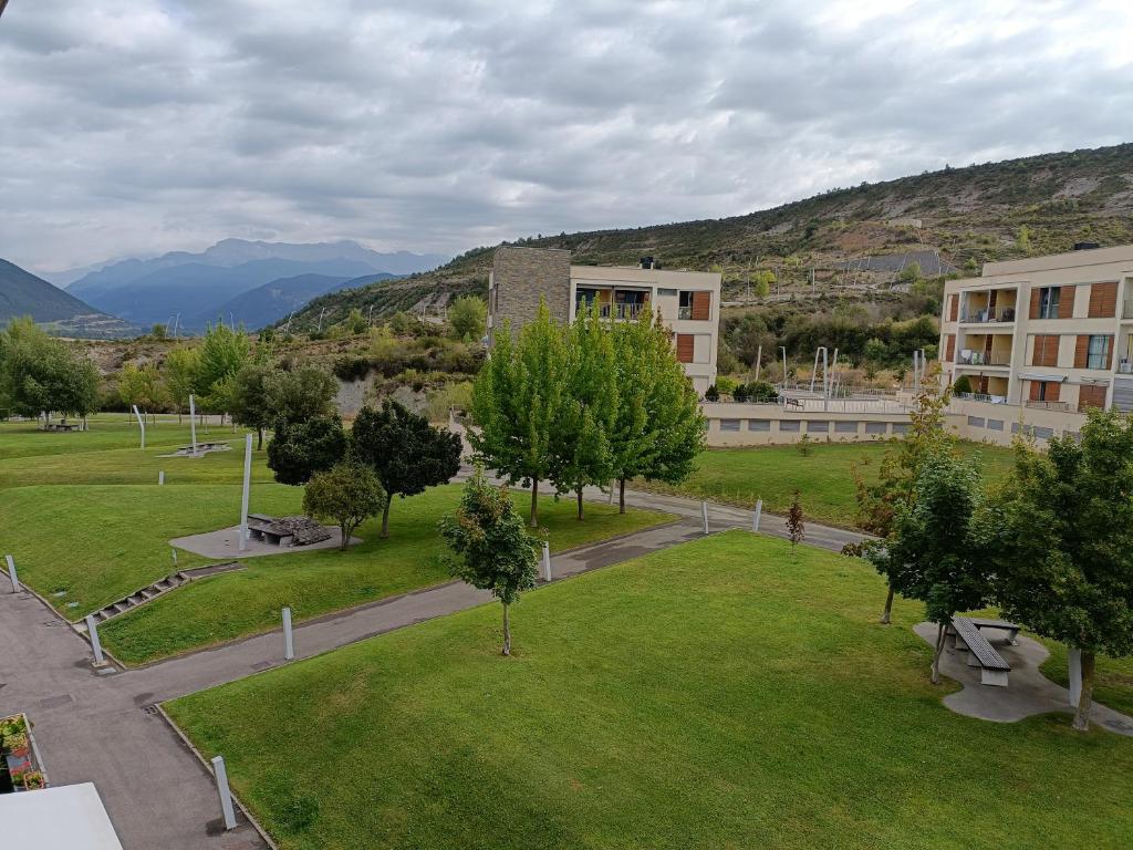 a view of a park with a building and trees at Sky, golf y senderismo in Sabiñánigo