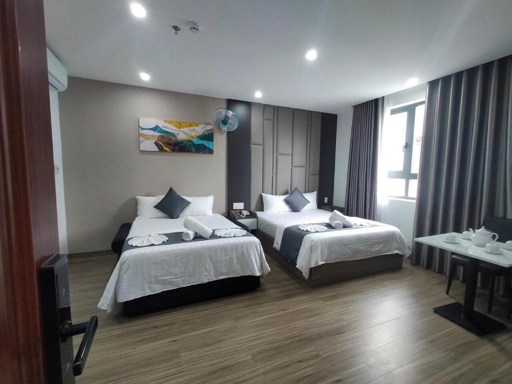 Postel nebo postele na pokoji v ubytování Seven Stars Hotel & Apartment