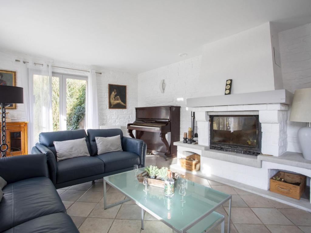 a living room with a couch and a fireplace at Villa Villa Bellevue by Interhome in Saint Paul de Vence