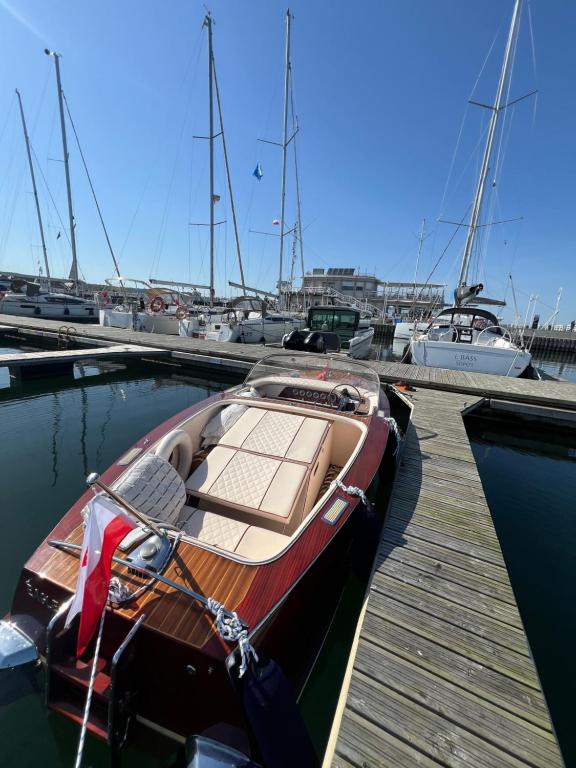 a boat is docked at a dock with other boats at Sopot Classic Boat in Sopot