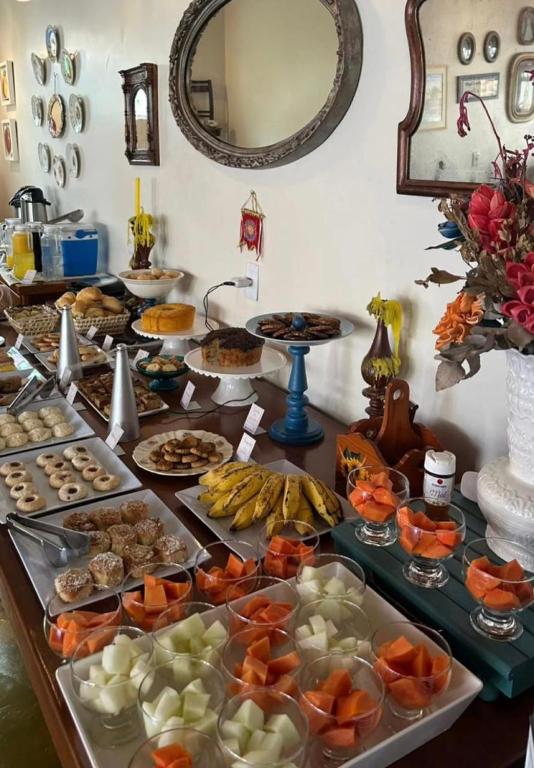 a buffet with many different types of food on a table at Pousada Mãe Natureza in Pirenópolis