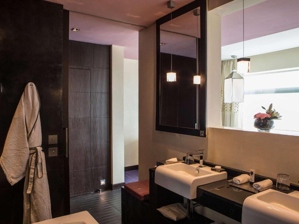 a bathroom with a sink and a mirror at Sofitel Casablanca Tour Blanche in Casablanca