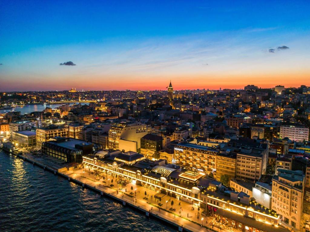 a view of a city at night at Novotel Istanbul Bosphorus Hotel in Istanbul