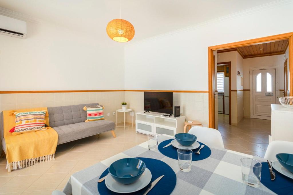 a living room with a couch and a table at TAC - Serenity Manta Rota in Vila Nova De Cacela