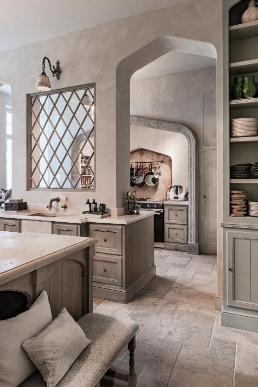 a large kitchen with a counter and a window at The Notary in Bruges