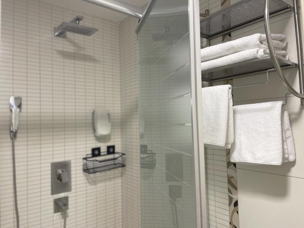 a bathroom with a shower with a glass door at Sienna Apartments in Skopje