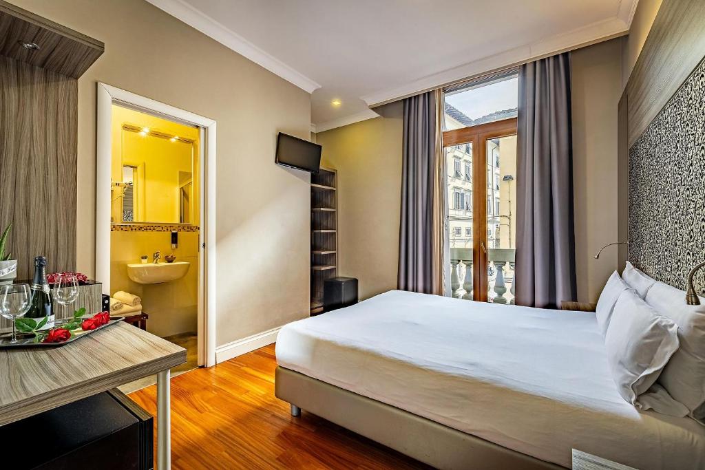 a hotel room with a bed and a bathroom at B&B Residenza le Fonticine in Florence