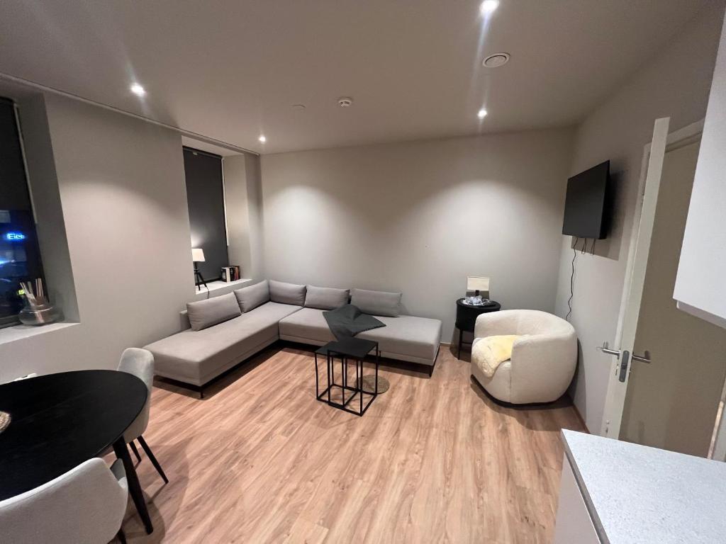 a living room with a couch and a table at Spacious Retreat in Oslo