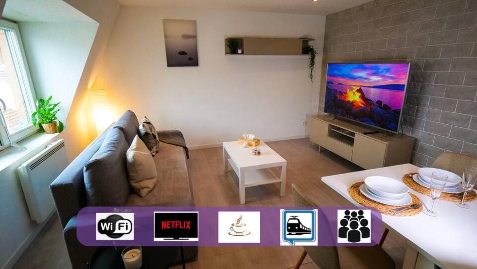 a living room with a couch and a flat screen tv at # Le 4 # Très beau appartement T3 Neuf, tout confort, Mulhouse centre ville in Mulhouse