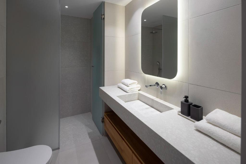 a bathroom with a sink and a mirror at Kechria Bay Villas in Skiathos