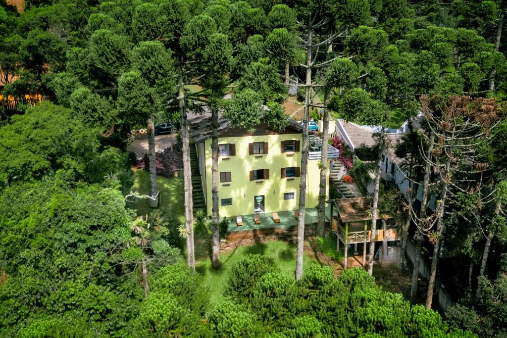 an aerial view of a house in the forest at Pousada Casa de Campos Guest House by Concavus in Campos do Jordão