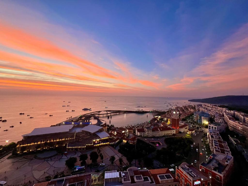 an aerial view of a city at sunset at Hillside Luxury Apartments by CASEPIA in Phu Quoc