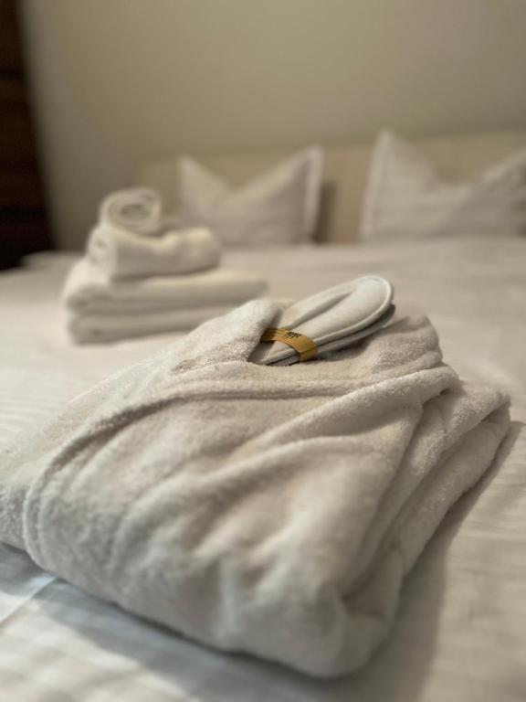 a white towel with a ring on top of a bed at Apartament Dor de Munte Cavnic in Cavnic