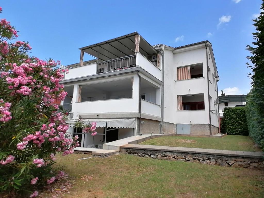 an image of a building with pink flowers at APARTMAN GLORIA in Krk